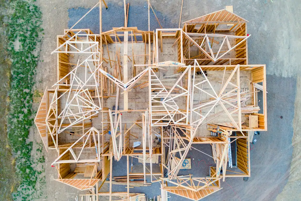 Aerial view of a house frame showing walls, rooms and roof trusses from above